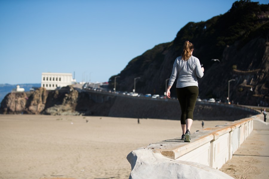 A woman walks on a beach path during the coronavirus pandemic on May 3, 2020 in San Francisco. (Rich Fury/Getty Images)