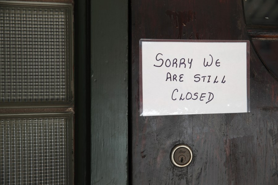 A sign on the door of Flannery's Tavern lets customers know the business is still closed on May 13, 2020, in Chesterton, Indiana. (Scott Olson/Getty Images)