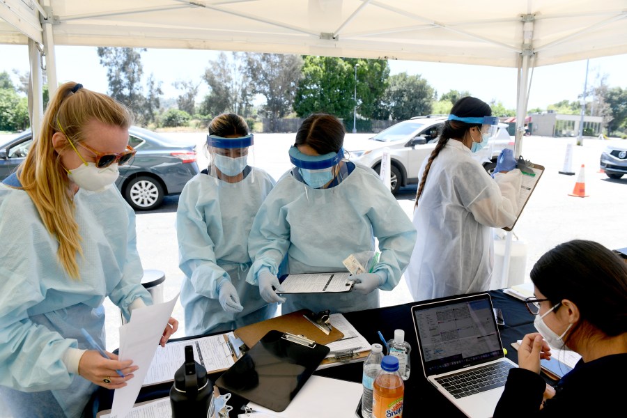 Workers perform drive-up coronavirus testing at the Westfield Fashion Square on May 13, 2020, in Sherman Oaks. (Kevin Winter/ Getty Images)