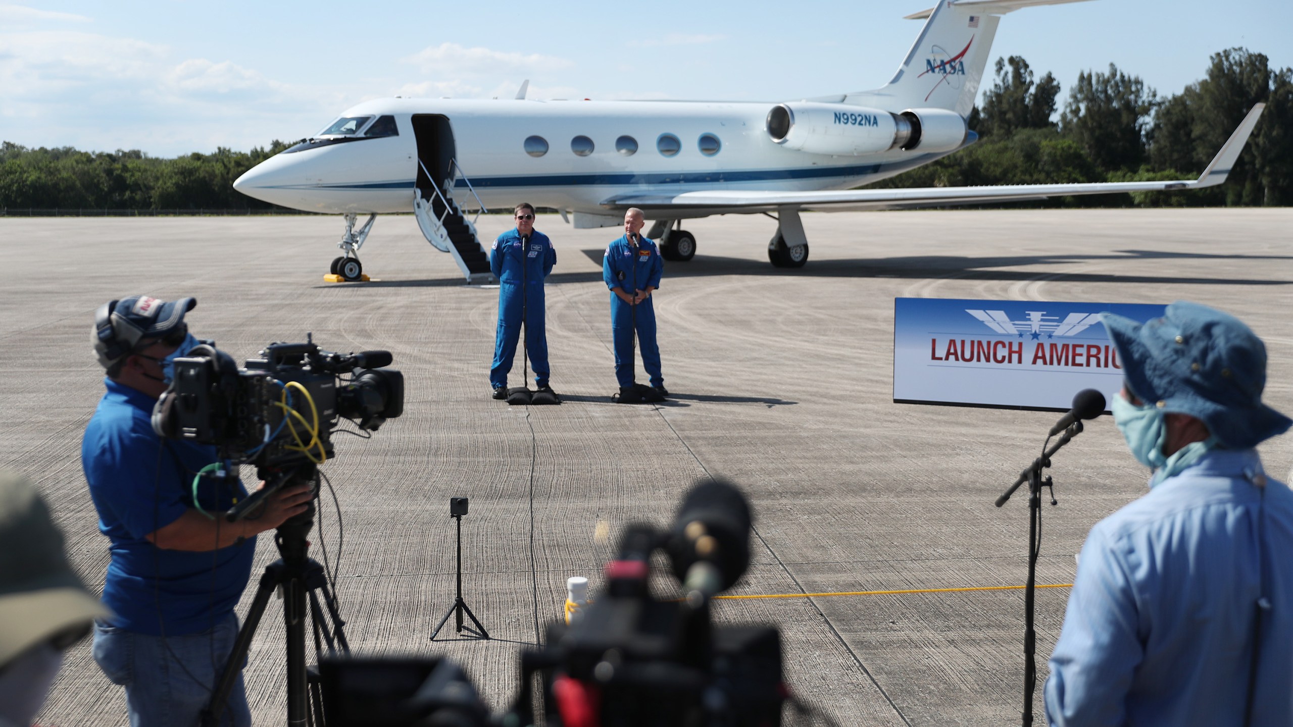 NASA astronauts Bob Behnken (L) and Doug Hurley speak to the media after arriving at the Kennedy Space Center on May 20, 2020, in Cape Canaveral, Florida. (Joe Raedle/Getty Images)