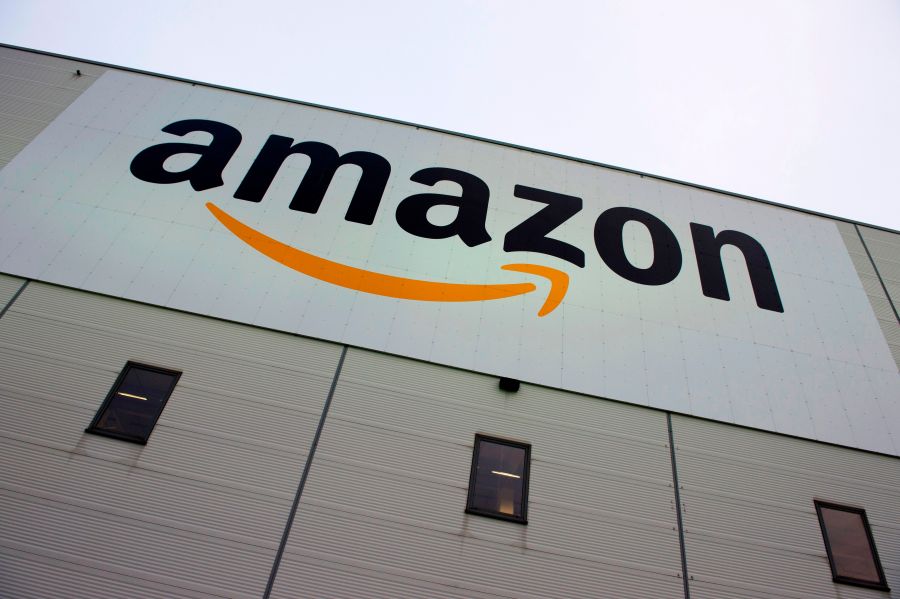 The logo of online retail giant Amazon is displayed on the Brieselang logistics center, west of Berlin on November 11, 2014. (JOHN MACDOUGALL/AFP via Getty Images)