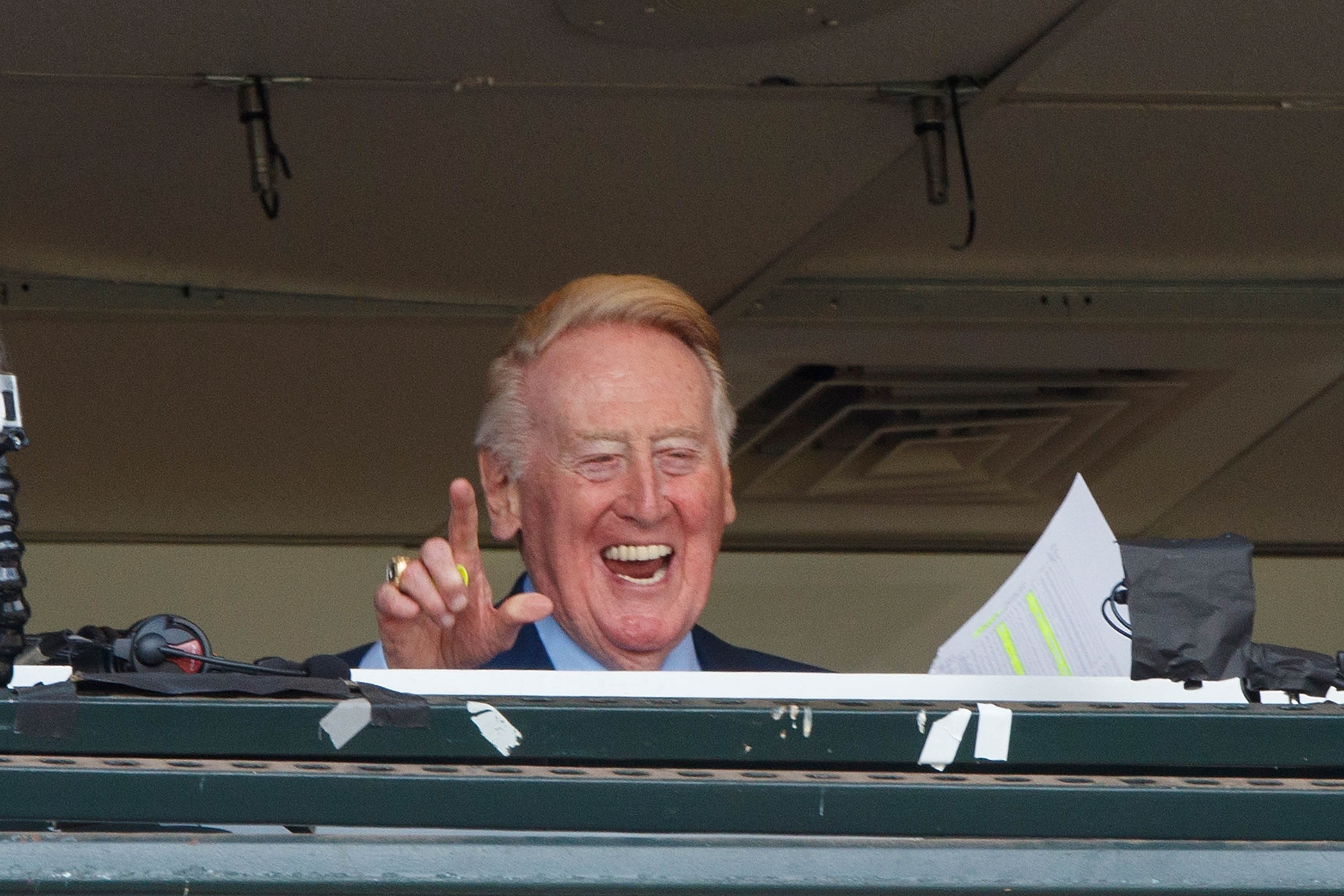 Vin Scully waves to fans in the broadcast booth before the game between the San Francisco Giants and the Los Angeles Dodgers at AT&T Park on October 2, 2016, in San Francisco. (Jason O. Watson/Getty Images)