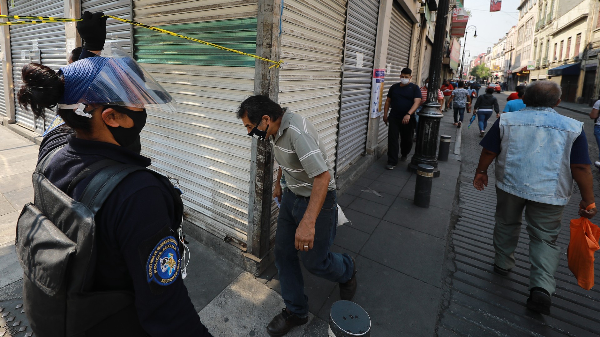 Police control the passage of people to Corregidora street where there are shops for construction products during health emergency to curb spread of COVID-19 on May 20, 2020 in Mexico City, Mexico. (Hector Vivas/Getty Images)