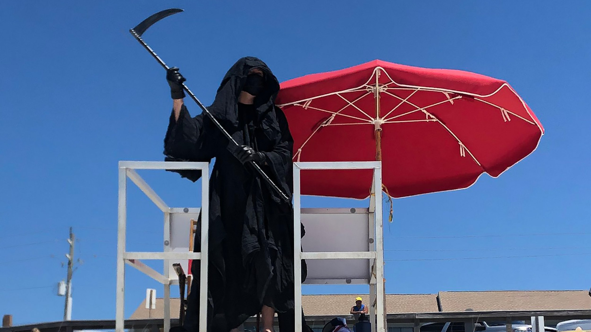 Daniel Uhlfelder is seem dressed as the Grim Reaper at a Florida beach. (Daniel Uhlfelder via CNN)