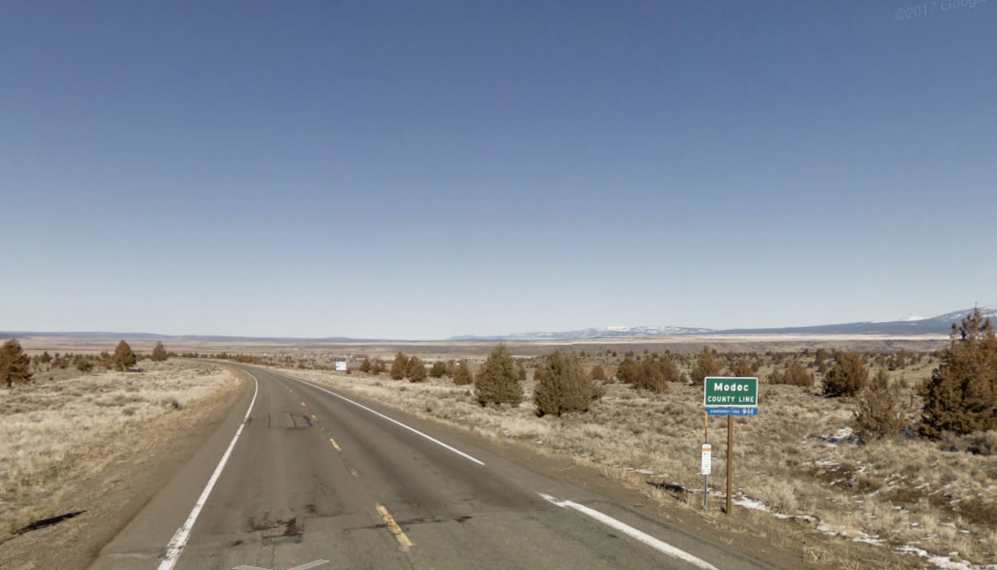 A sign showing southern boundary of Modoc County on U.S. 395 is shown in a Google Maps Street View image.