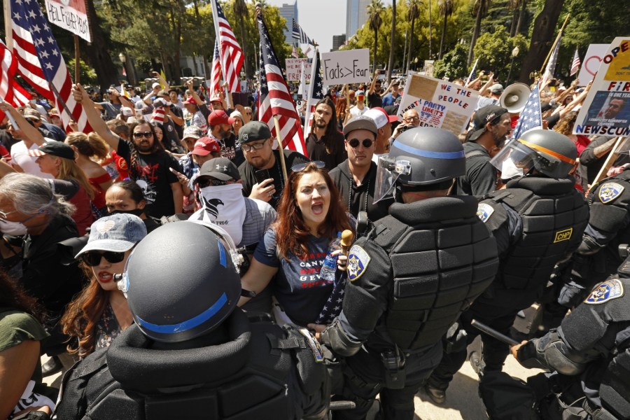 Alicia Cruz, center, of El Grove, takes part in a protest at the California State Capitol on May 1, 2020. (Credit: Carolyn Cole / Los Angeles Times)