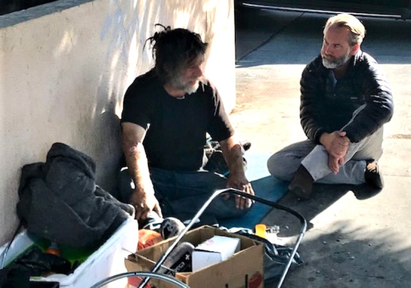 Dr. Jonathan Sherin, director of the Los Angeles County Department of Mental Health, counsels a man who is homeless in Hollywood in October 2019.(Steve Lopez / Los Angeles Times)