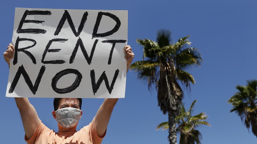 A protester demands rent forgiveness for the month of April due to the coronavirus pandemic’s economic fallout. (Los Angeles Times)