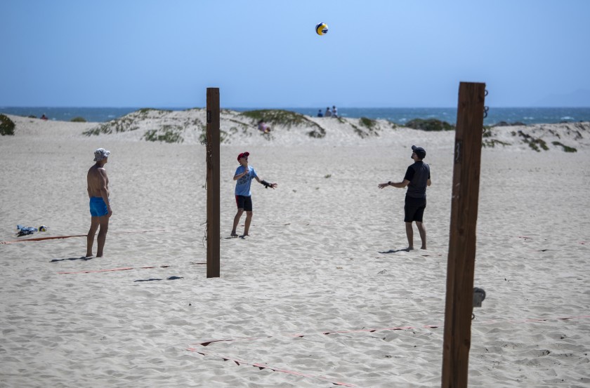 Beachgoers hit a volleyball around at Harbor Cove Beach in Ventura on May 2, 2020.(Brian van der Brug / Los Angeles Times)