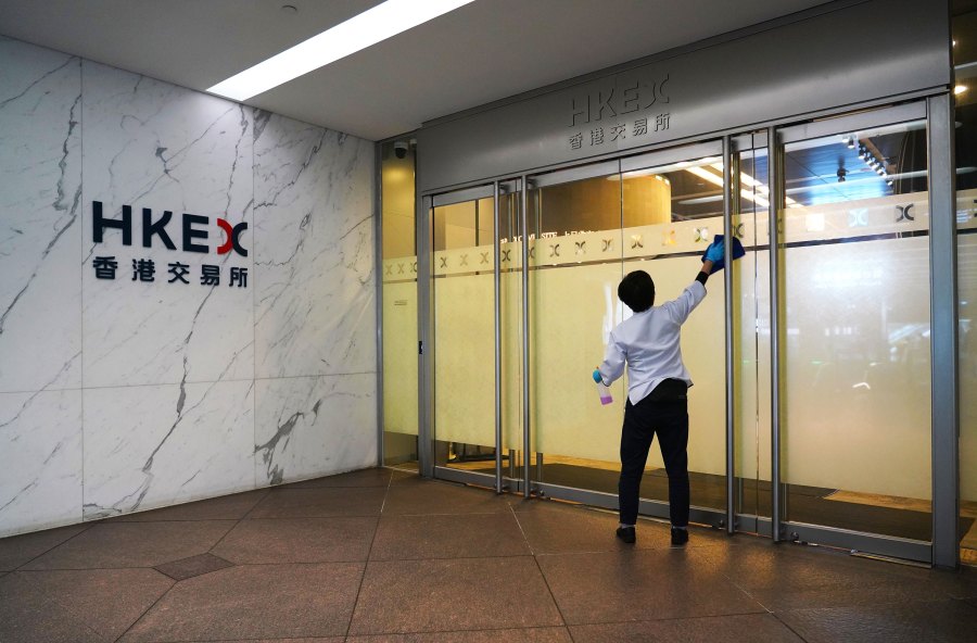 A cleaner disinfects a door of HKEX (Hong Kong Stock Exchange) Connect Hall on March 27, 2020 in Hong Kong, China. (Zhang Wei/China News Service/Getty Images)