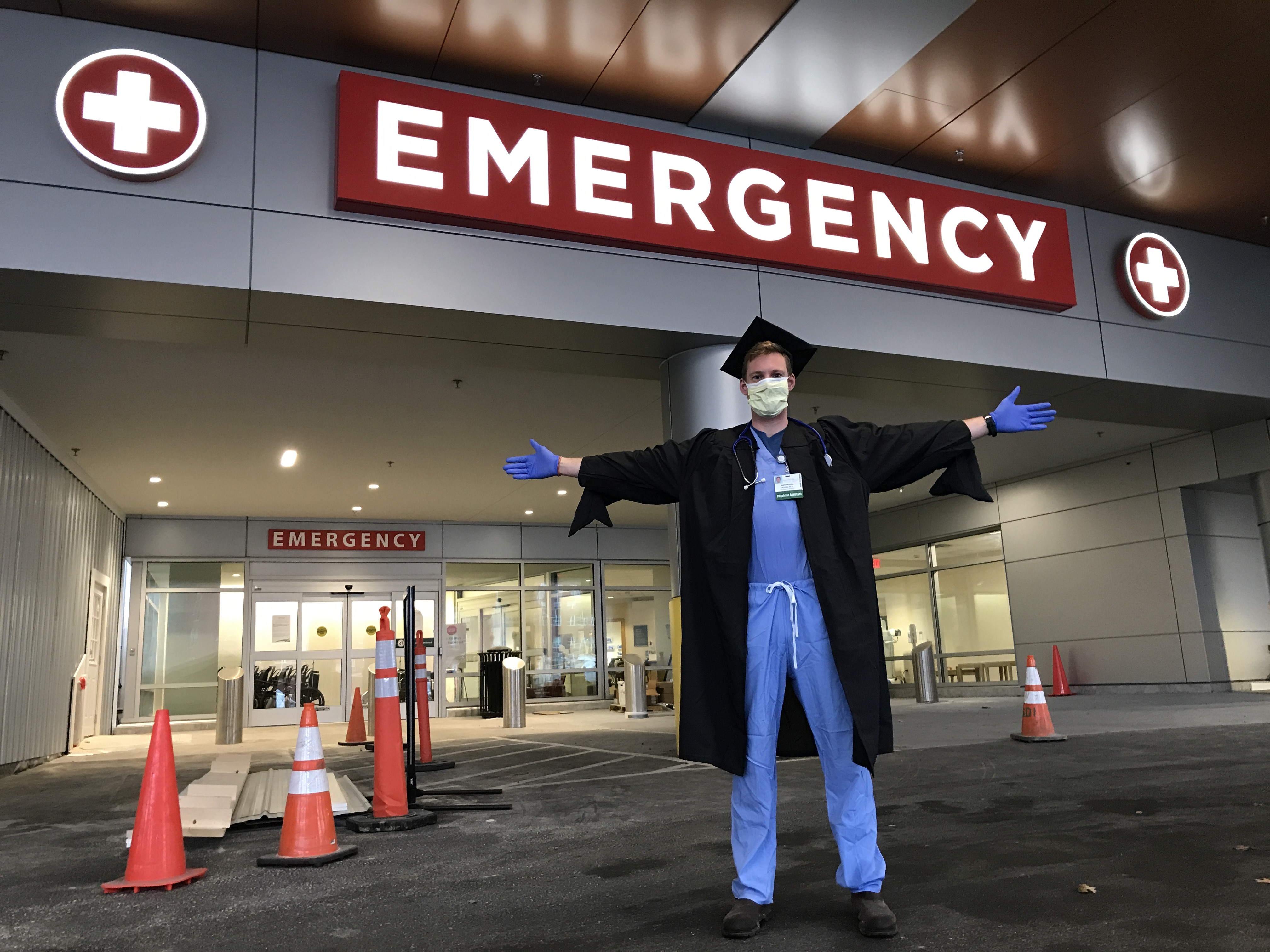 Nathaniel Moore wearing his cap and gown outside of University of Vermont Medical Center in Burlington, Vermont. (Courtesy Gowns 4 Good)