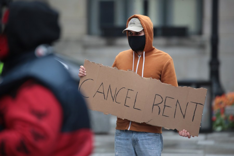 A demonstrator calls on the governor to suspend rent and mortgage payments to help those who have lost their income due to the coronavirus during a protest on April 30, 2020 in Chicago, Illinois. (Scott Olson/Getty Images)