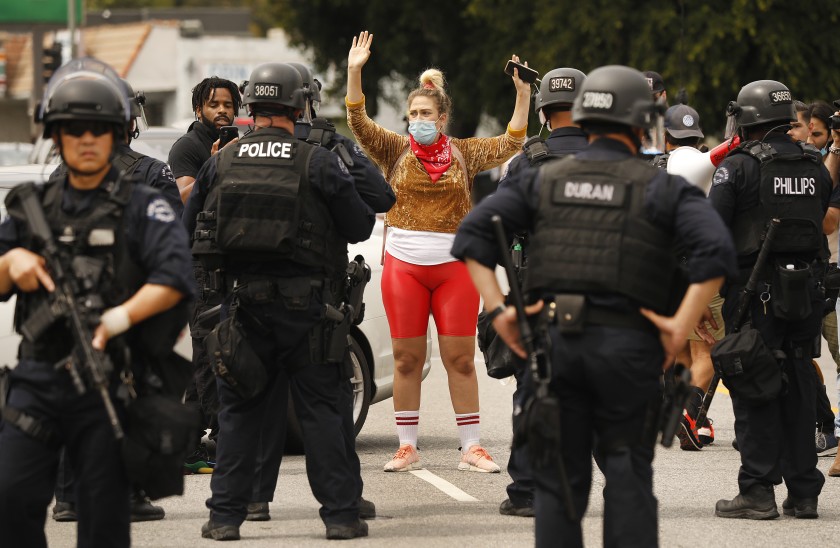 LAPD officers move protesters up Cahuenga Boulevard to Yucca Street in Hollywood.(Al Seib / Los Angeles Times)