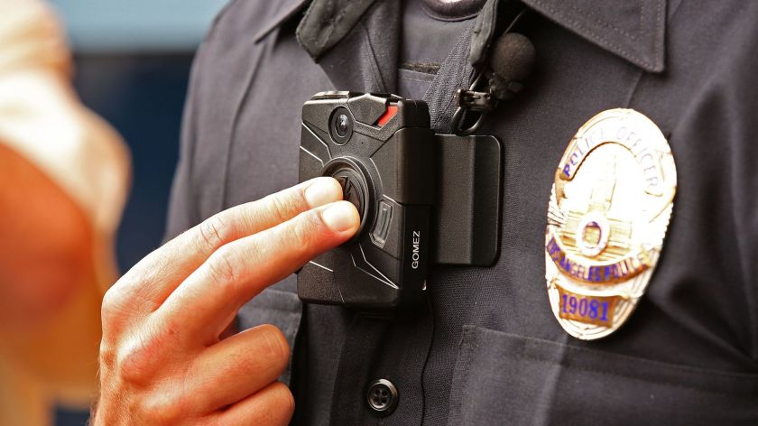 An LAPD officer demonstrates the use of a body camera in an undated photo. (Los Angeles Times)