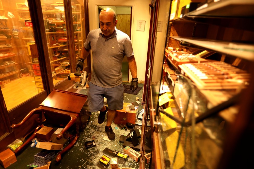 Moe, owner of Santa Monica Tobacco, walks through his business, which was looted and burned Sunday in Santa Monica on May 31, 2020.(Genaro Molina / Los Angeles Times)