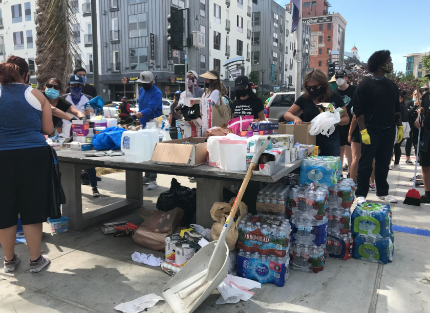 Volunteers help with cleanup after protests in Long Beach on June 1, 2020. (Los Angeles Times)