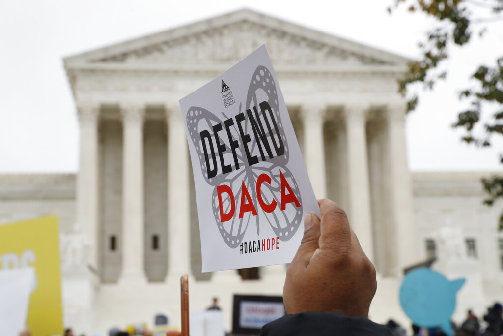 In this Nov. 12, 2019, file photo people rally outside the Supreme Court as oral arguments are heard in the case of President Trump's decision to end the Obama-era, Deferred Action for Childhood Arrivals program (DACA), at the Supreme Court in Washington. DACA recipients are assuming a prominent role in the presidential campaign, working to get others to vote, even though they cannot cast ballots themselves, and becoming leaders in the Democratic campaigns of Bernie Sanders and Tom Steyer as well as get-out-the-vote organizations. (AP Photo/Jacquelyn Martin, File)