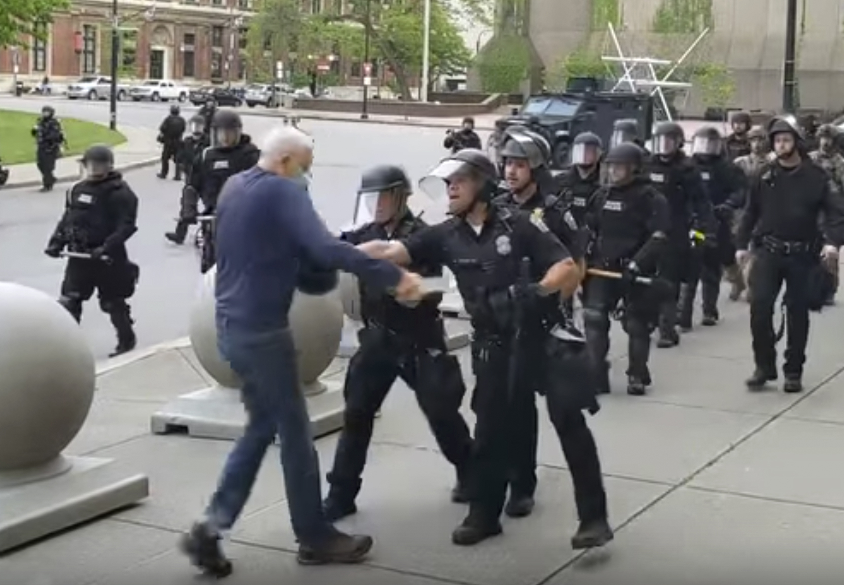 In this image from video provided by WBFO, a police officer shoves a man who walked up to police June 4, 2020, in Buffalo, New York.