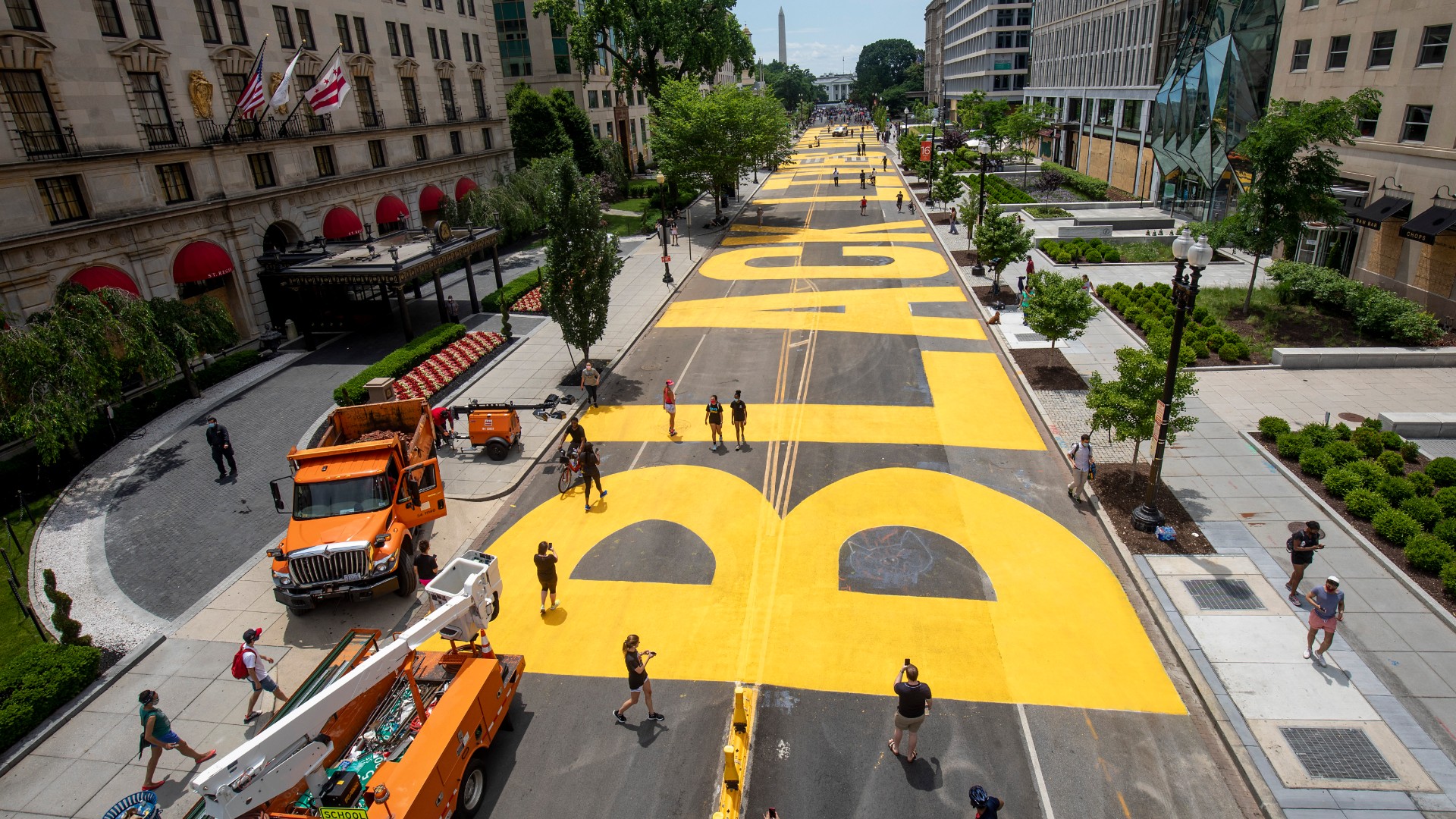 People walk down 16th street after volunteers, with permission from the city, painted "Black Lives Matter" on the street near the White House on June 05, 2020, in Washington, DC. (Tasos Katopodis/Getty Images)