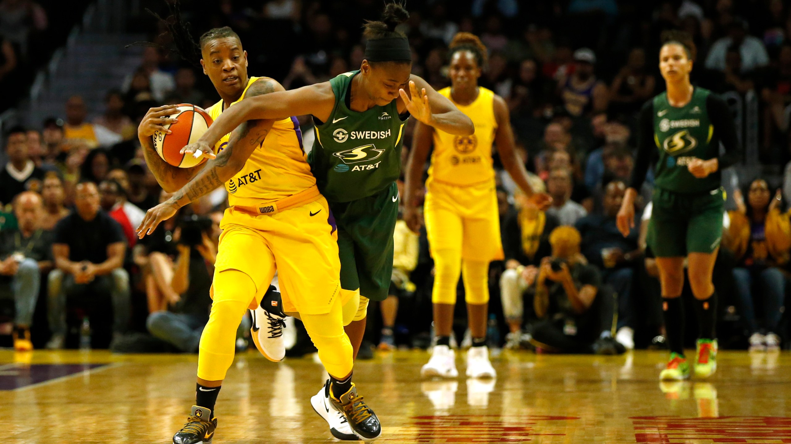 Guard Riquna Williams #2 of the Los Angeles Sparks and guard Jewell Loyd #24 of the Seattle Storm fight for a jump ball during the second half of a game at Staples Center on Sept. 15, 2019. (Katharine Lotze/Getty Images)