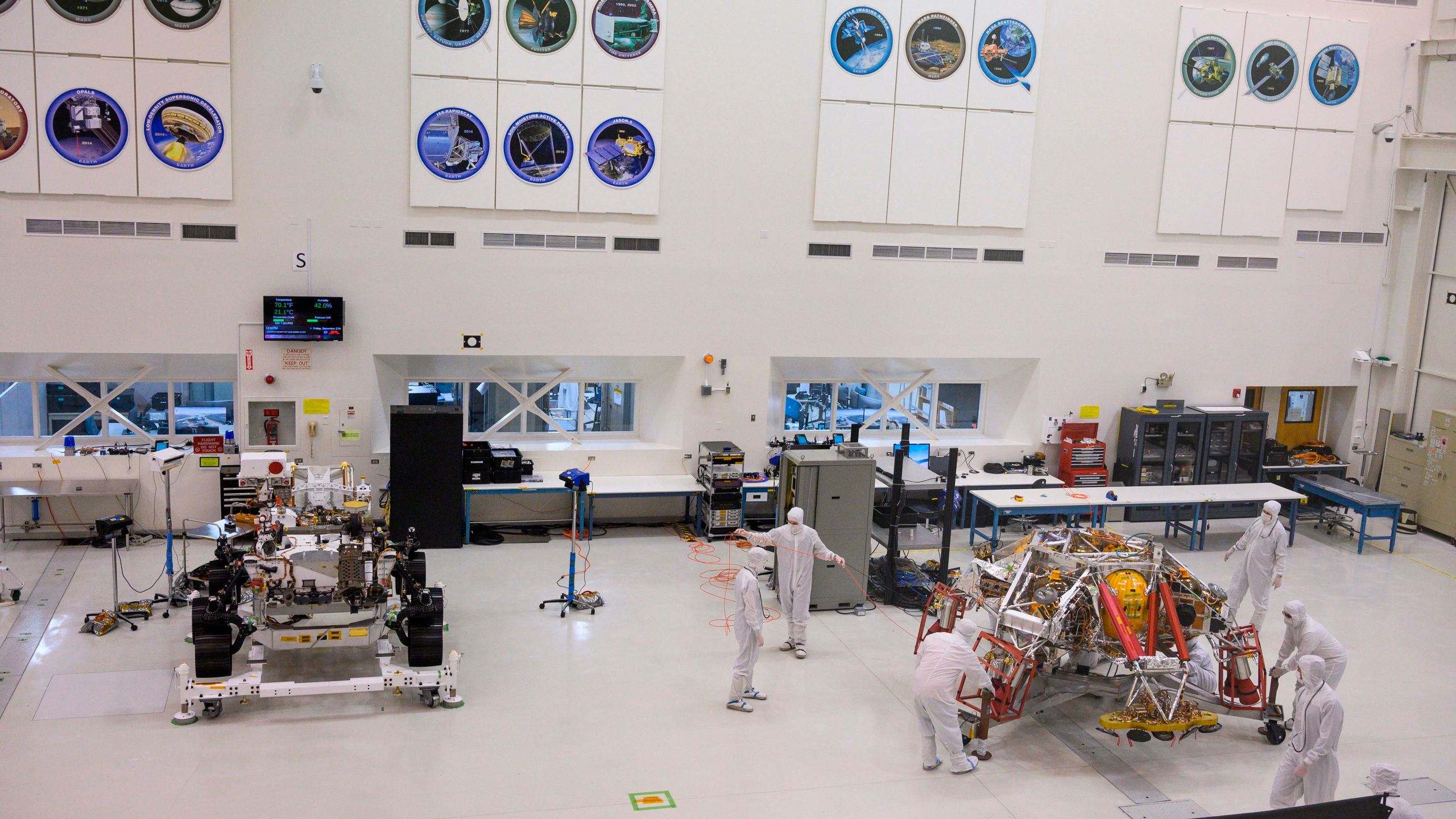 NASA engineers and technicians move the Mars 2020 spacecraft descent stage on Dec. 27, 2019, during a media tour of the spacecraft assembly area clean room at NASA's Jet Propulsion Laboratory in Pasadena. (ROBYN BECK/AFP via Getty Images)