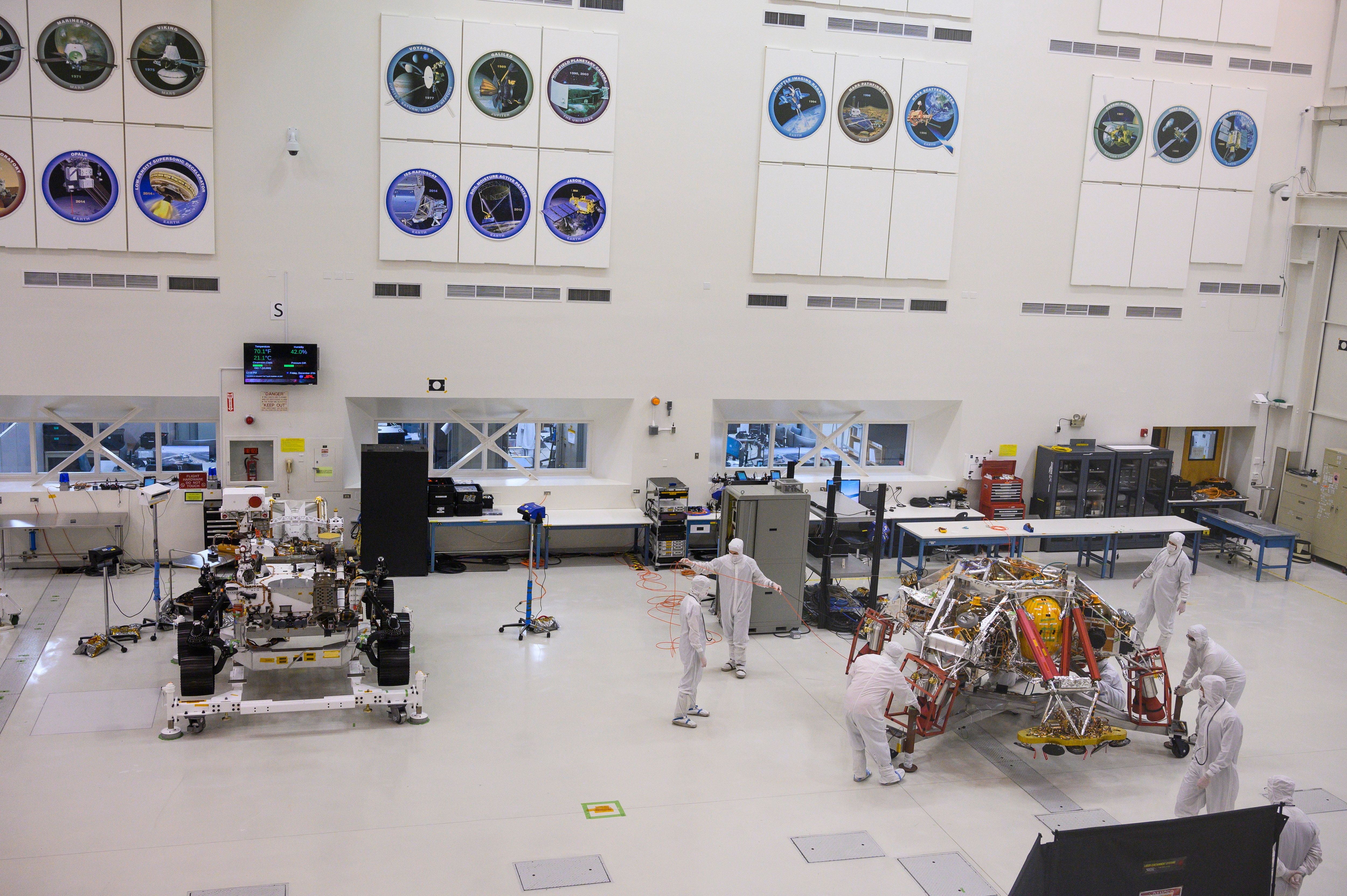 NASA engineers and technicians move the Mars 2020 spacecraft descent stage on Dec. 27, 2019, during a media tour of the spacecraft assembly area clean room at NASA's Jet Propulsion Laboratory in Pasadena. (ROBYN BECK/AFP via Getty Images)