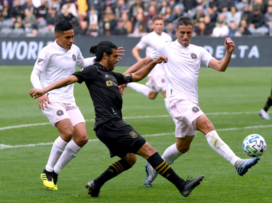 Carlos Vela #10 of Los Angeles FC attempts a cross in front of Victor Ulloa #13 and Ben Sweat #22 of Inter Miami CF during the first half at Banc of California Stadium on March 1, 2020. (Harry How/Getty Images)