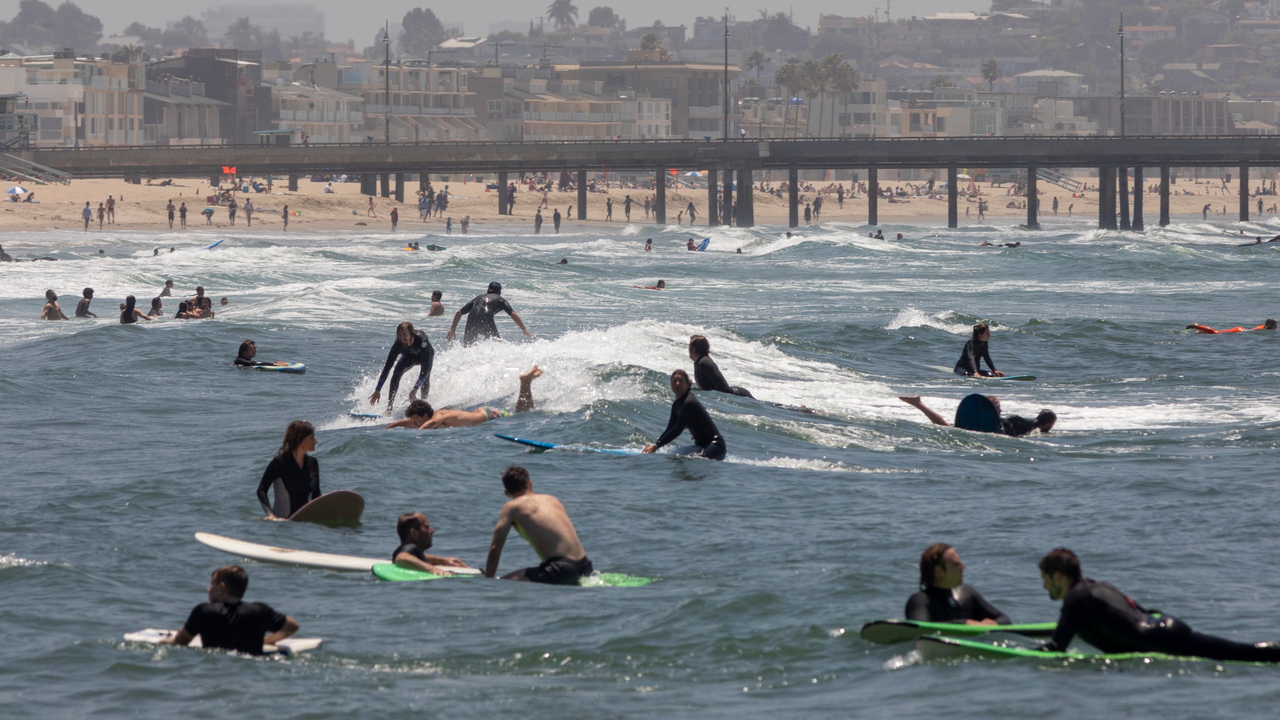 Holiday beachgoers enjoying the surf at Venice Beach. (David McNew/Getty Images)