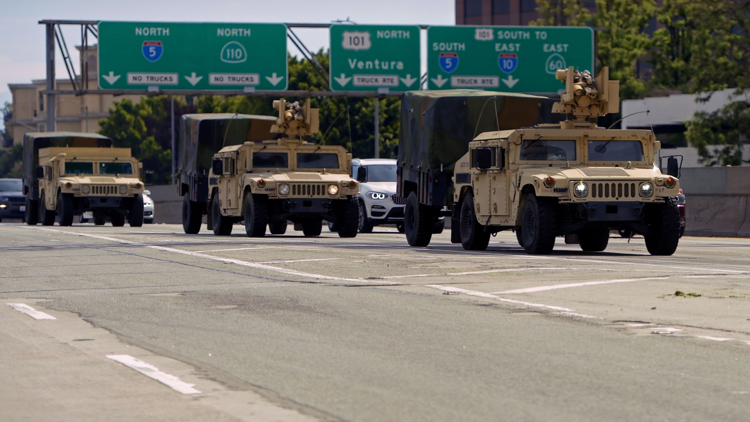 California National Guard armed vehicles are seen on the freeway as they patrol after demonstrators protested the death of George Floyd in Los Angeles on May 31, 2020. (Agustin Paullier / AFP / Getty Images)