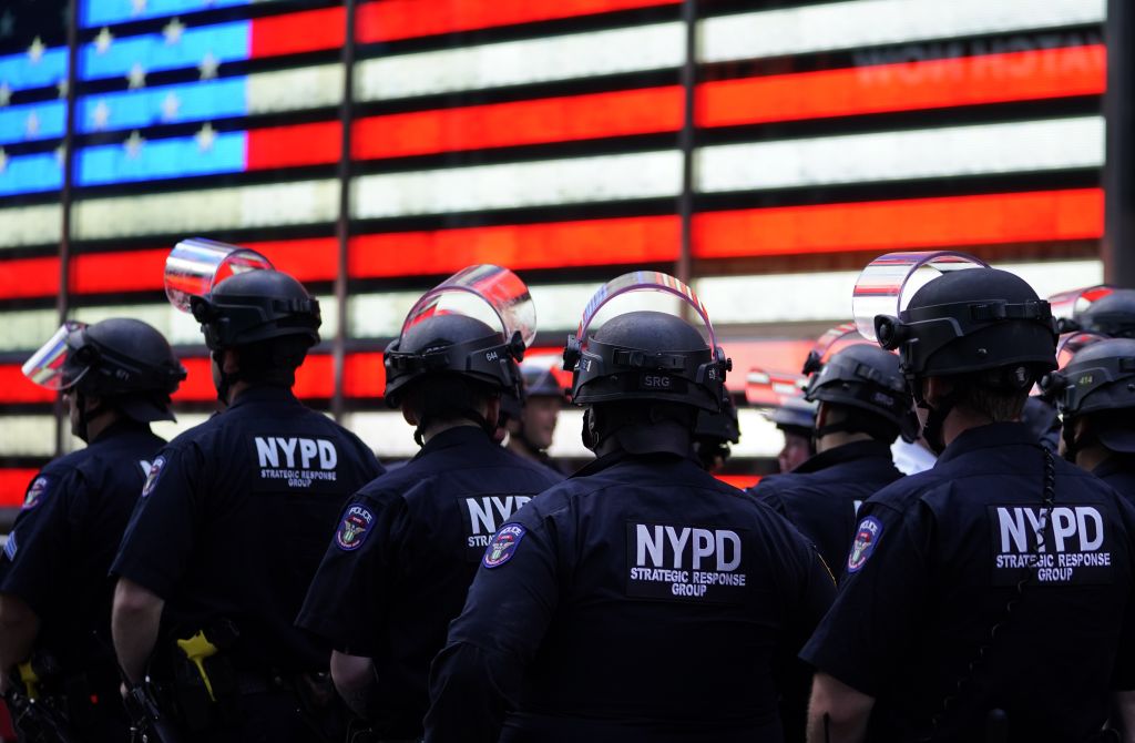 NYPD police officers watch demonstrators in Times Square on June 1, 2020, during a Black Lives Matter protest. (TIMOTHY A. CLARY/AFP via Getty Images)