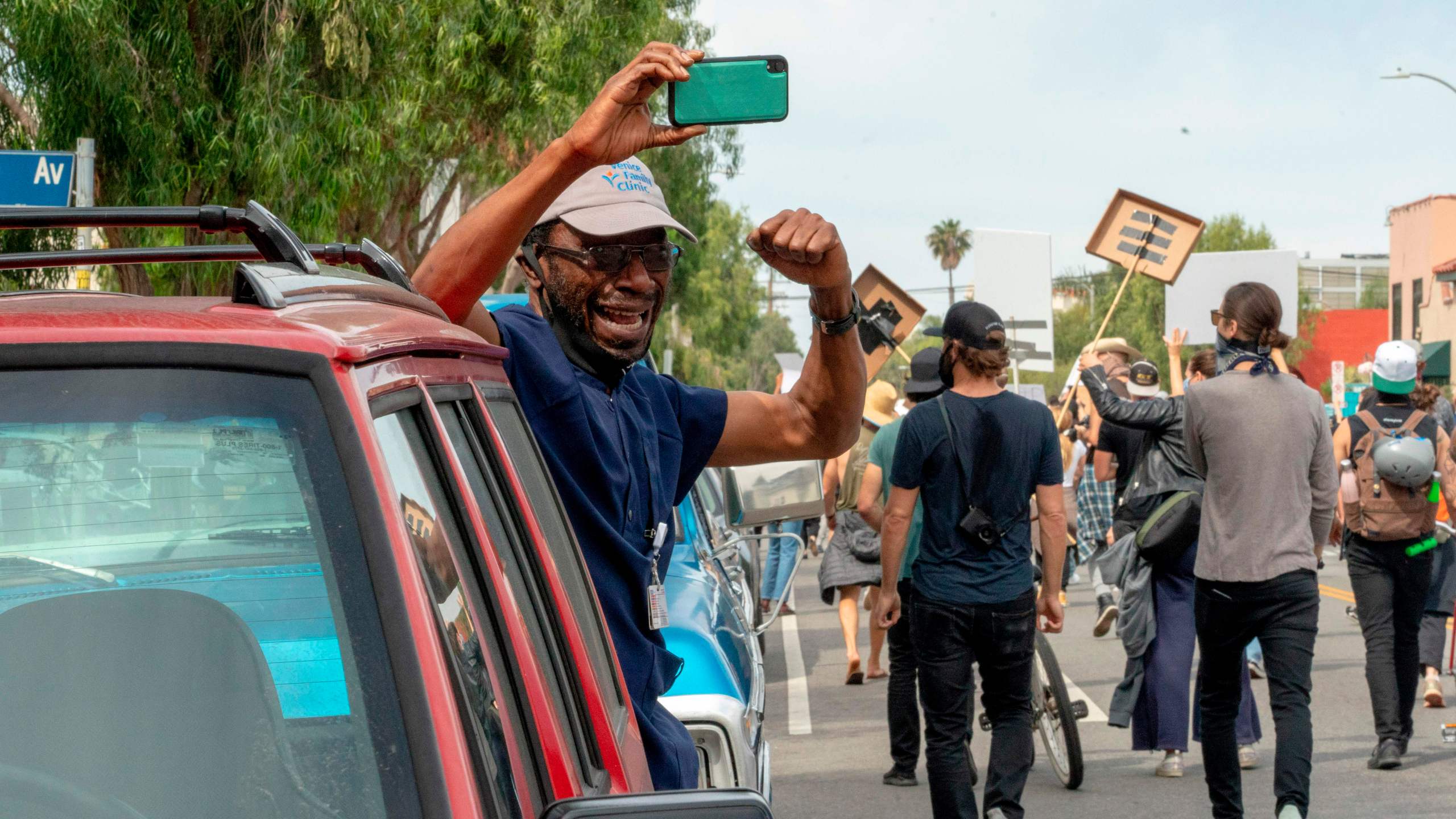 Tunde Obazee becomes emotional while taking a break from his job to cheer on marchers in Venice during a demonstration over the death of George Floyd in Los Angeles on June 2, 2020. (KYLE GRILLOT/AFP via Getty Images)