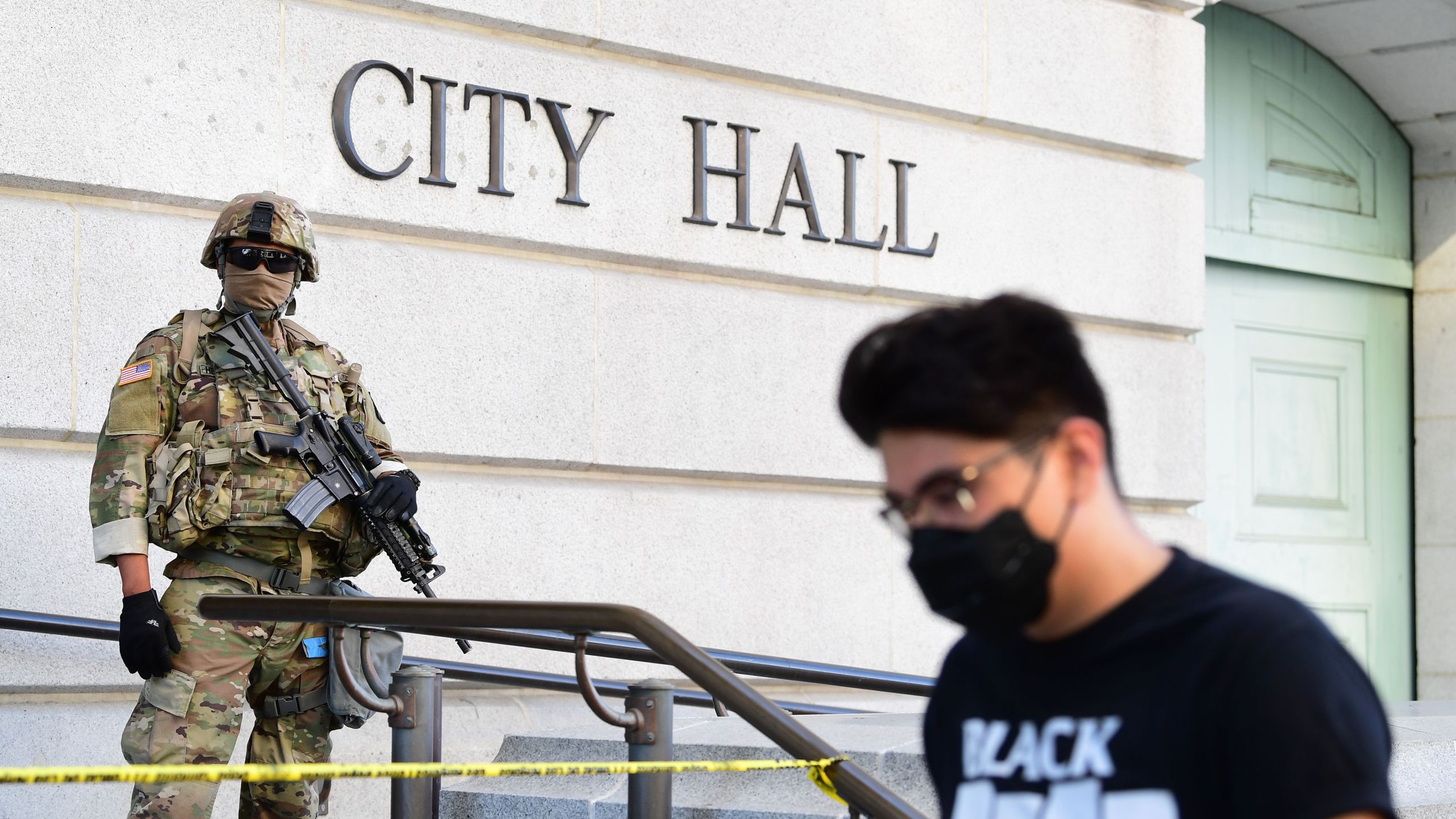 An armed National Guard mans his position in front of Los Angeles City Hall as people protest the death of George Floyd, who died in police custody, on June 3, 2020. (FREDERIC J. BROWN/AFP via Getty Images)