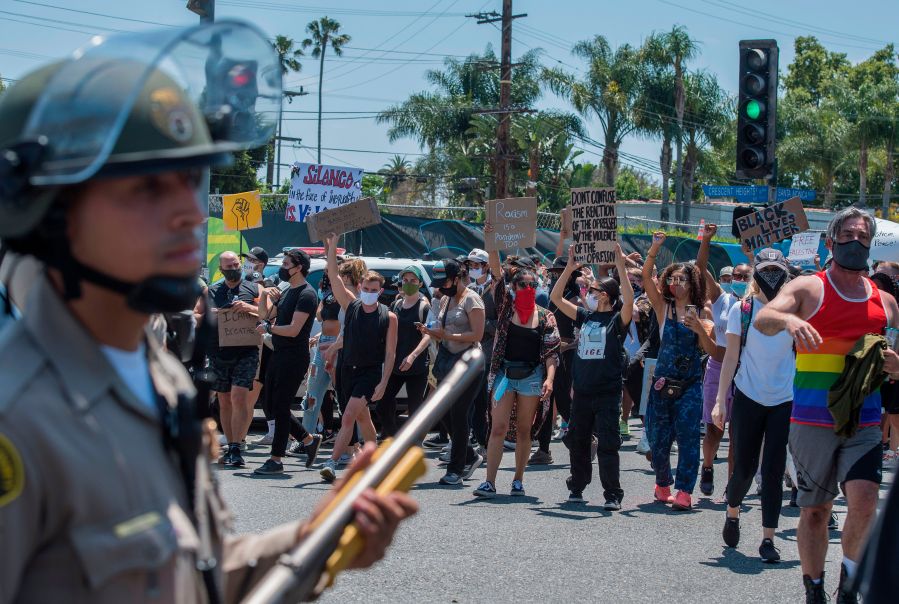 Deputies from the Los Angeles County Sheriff's Department keep watch as demonstrators continue to protest the death of George Floyd in West Hollywood on June 3, 2020. (Mark Ralston / AFP / Getty Images)