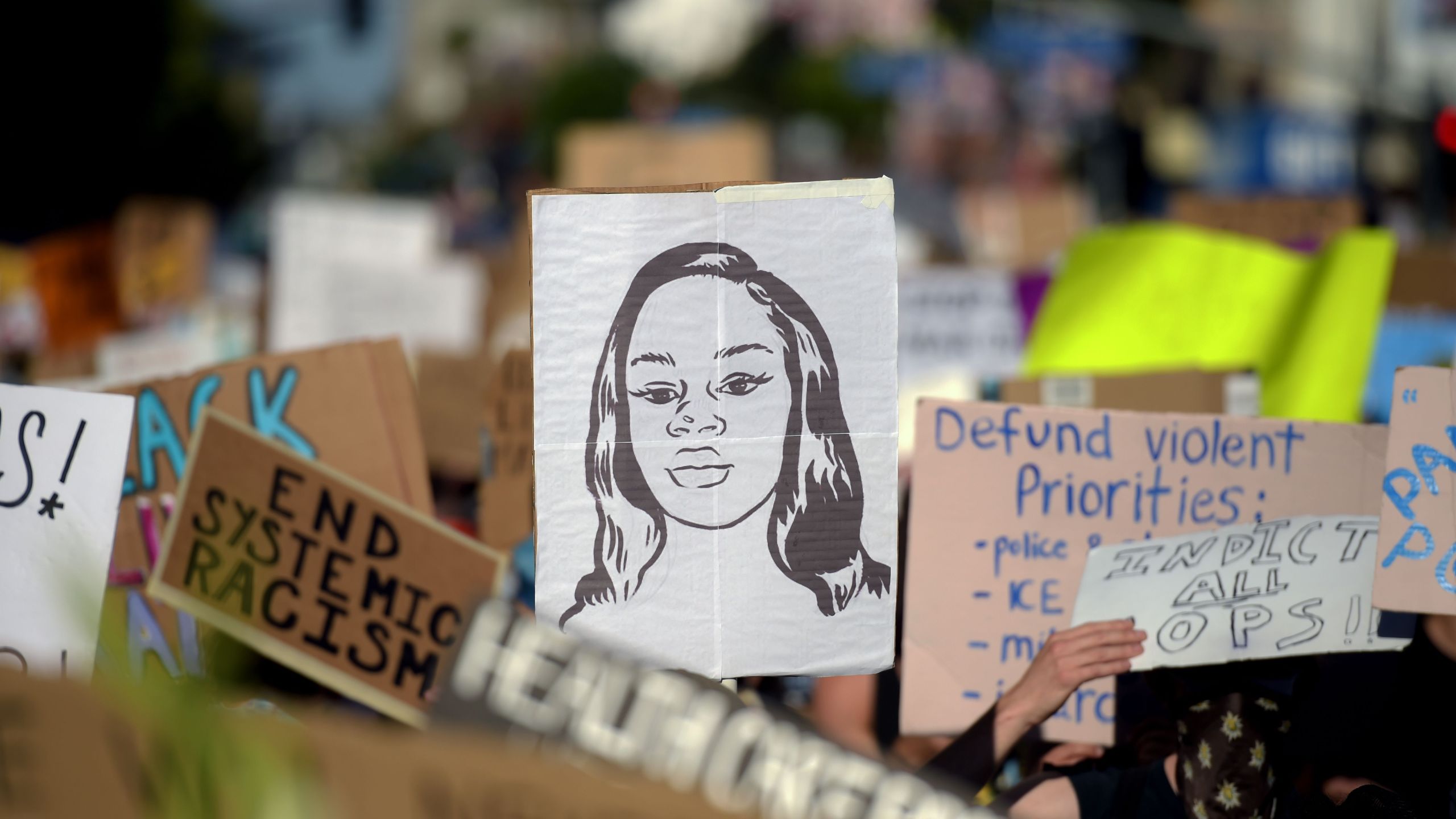 Protesters march holding placards and a portrait of Breonna Taylor during a demonstration against racism and police brutality, in Hollywood on June 7, 2020. (AGUSTIN PAULLIER/AFP via Getty Images)