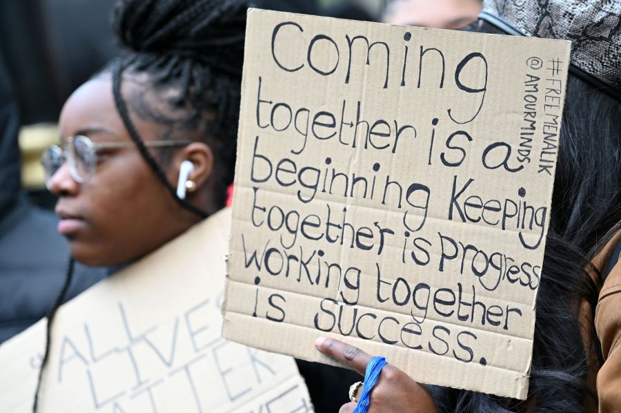 Demonstrators hold placards during a Stand up to Racism protest outside of Downing Street on Whitehall, central London, on June 9, 2020, in solidarity with the Black Lives Matter movement in the wake of the killing of George Floyd, an unarmed black man who died after a police officer knelt on his neck in Minneapolis, U.S. (JUSTIN TALLIS/AFP via Getty Images)