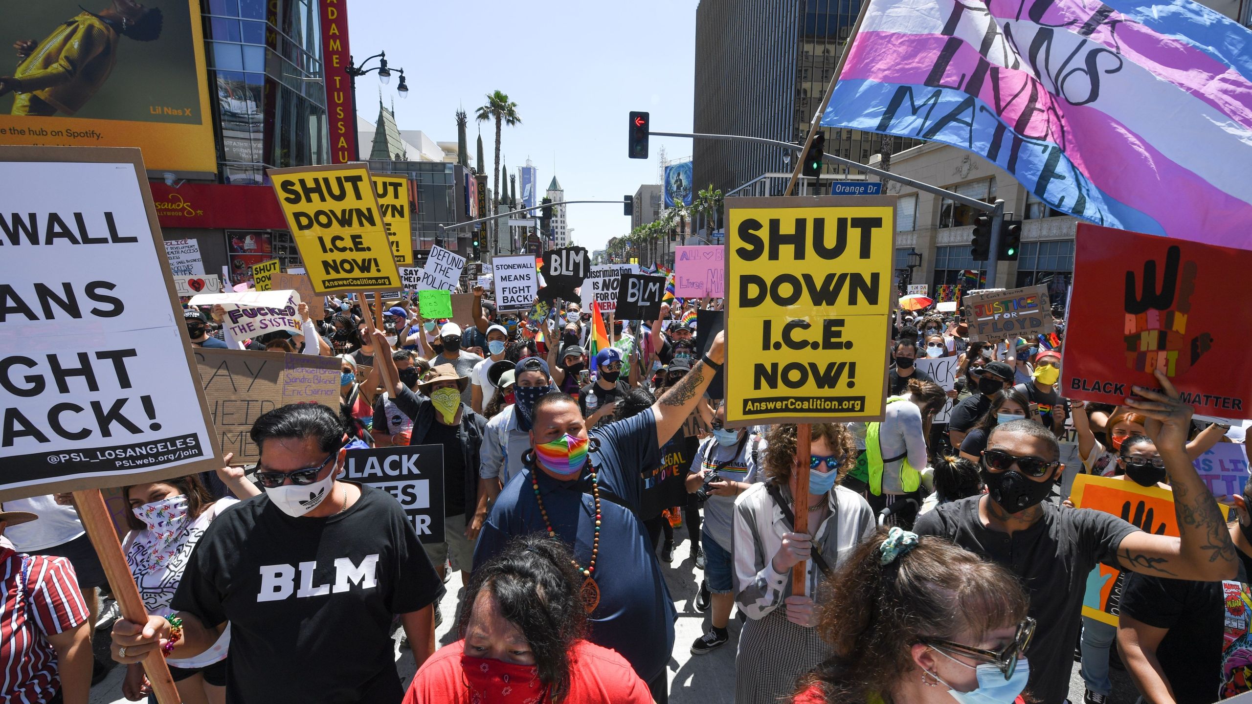 Protesters hold signs and chant slogans at a rally and march against racism and police brutality organized by leaders of black LGBTQ rights groups and attended by a large LGBTQ+ community and supporters, June 14, 2020 in Hollywood California. (ROBYN BECK/AFP via Getty Images)