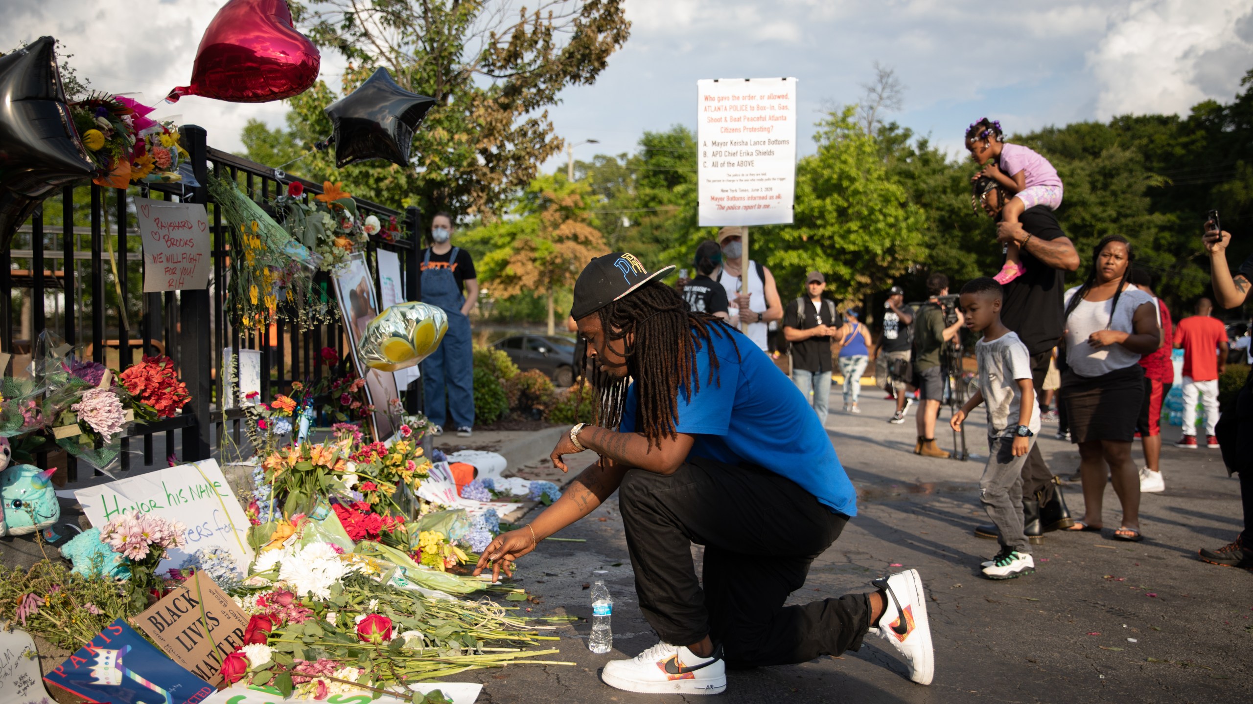 A man kneels at the memorial for Rayshard Brooks on June 14, 2020 in Atlanta, Georgia. (Dustin Chambers/Getty Images)