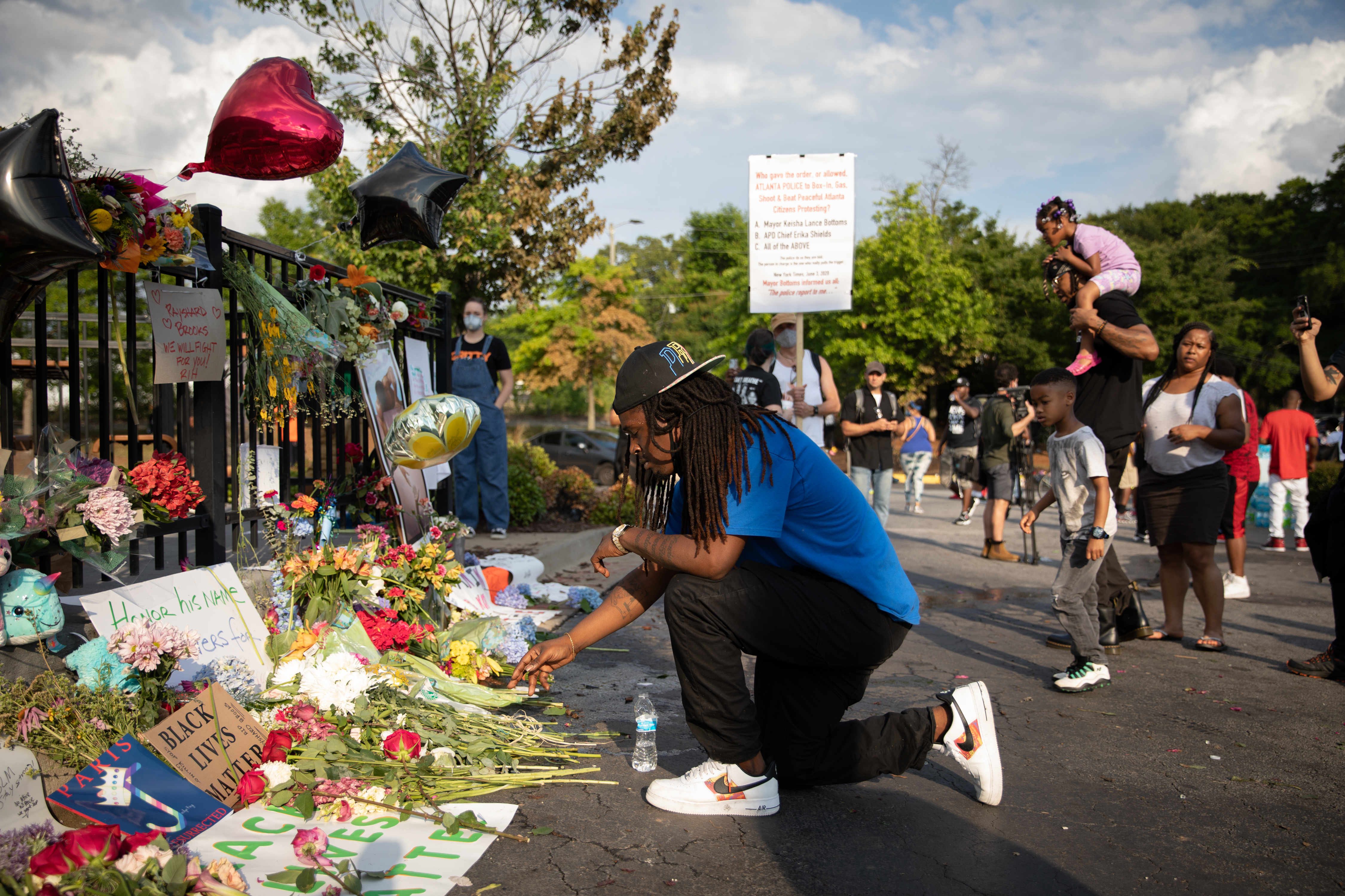 A man kneels at the memorial for Rayshard Brooks on June 14, 2020 in Atlanta, Georgia. (Dustin Chambers/Getty Images)