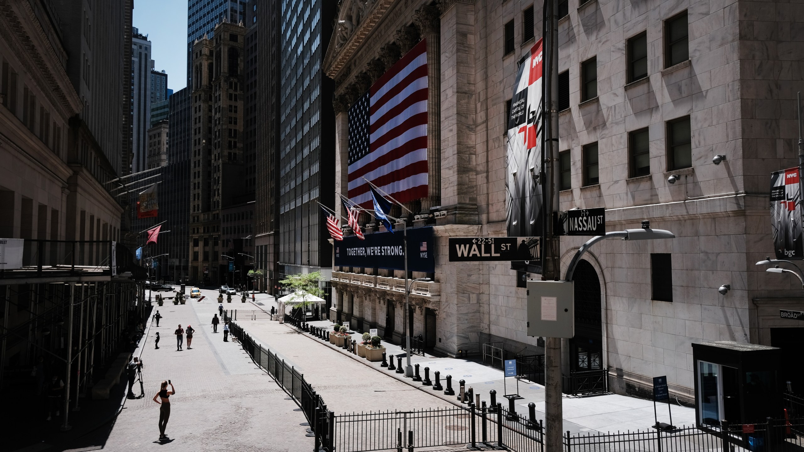 Journalists and others gather outside the New York Stock Exchange on the first day that traders are allowed back onto the historic floor of the exchange on May 26, 2020 in New York City. (Spencer Platt/Getty Images)