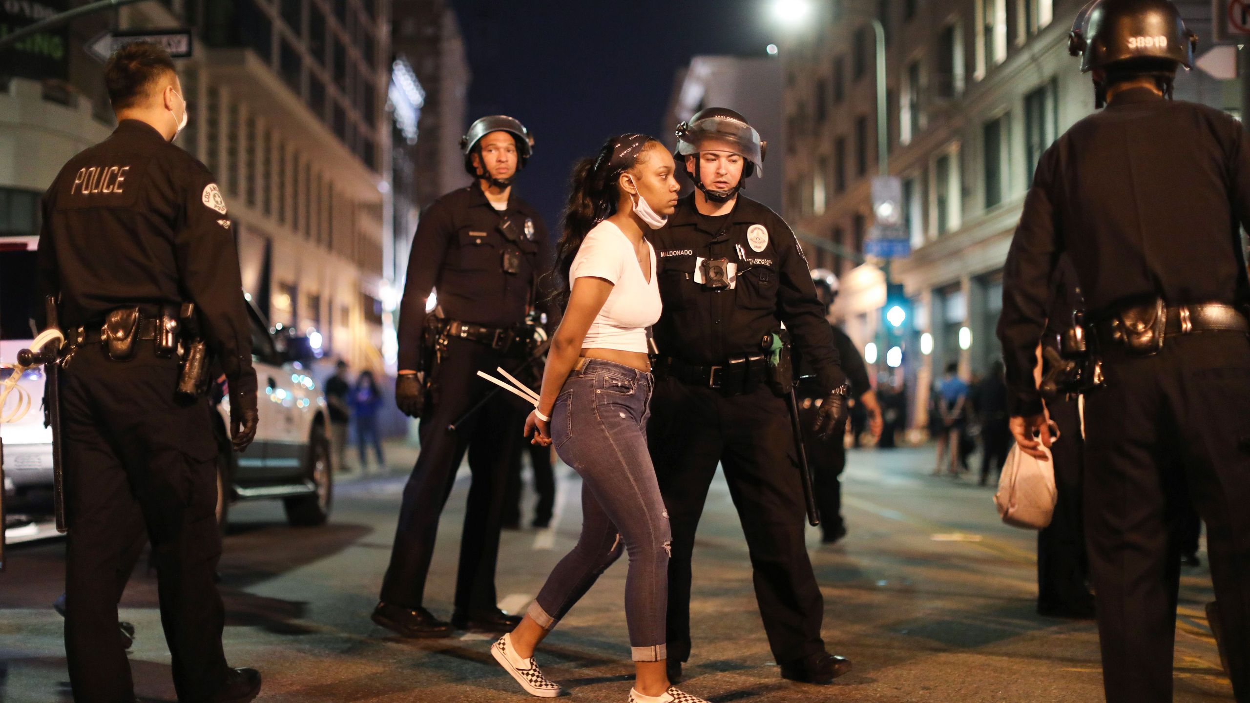 A woman is arrested after curfew went into effect during mostly peaceful demonstrations over George Floyd’s death in downtown Los Angeles on June 2, 2020. (Mario Tama/Getty Images)