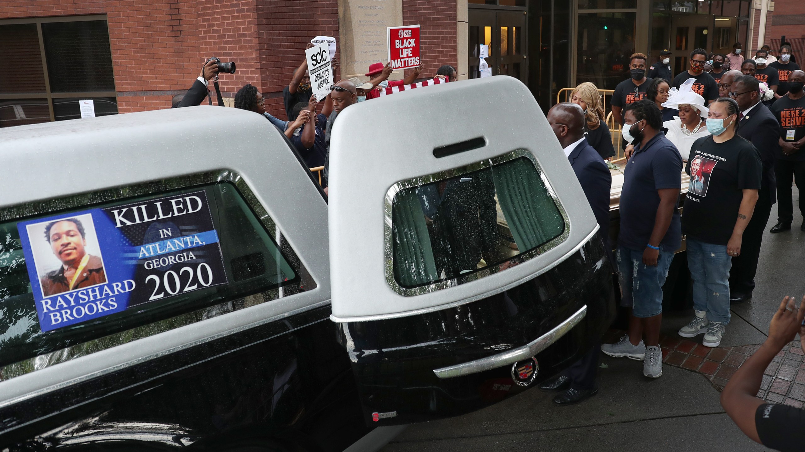 Tomika Miller (in white dress) the widow of Rayshard Brooks follows behind as pallbearers bring the remains of her husband to the hearse after a viewing at the Ebenezer Baptist Church on June 22, 2020 in Atlanta, Georgia. (Joe Raedle/Getty Images)