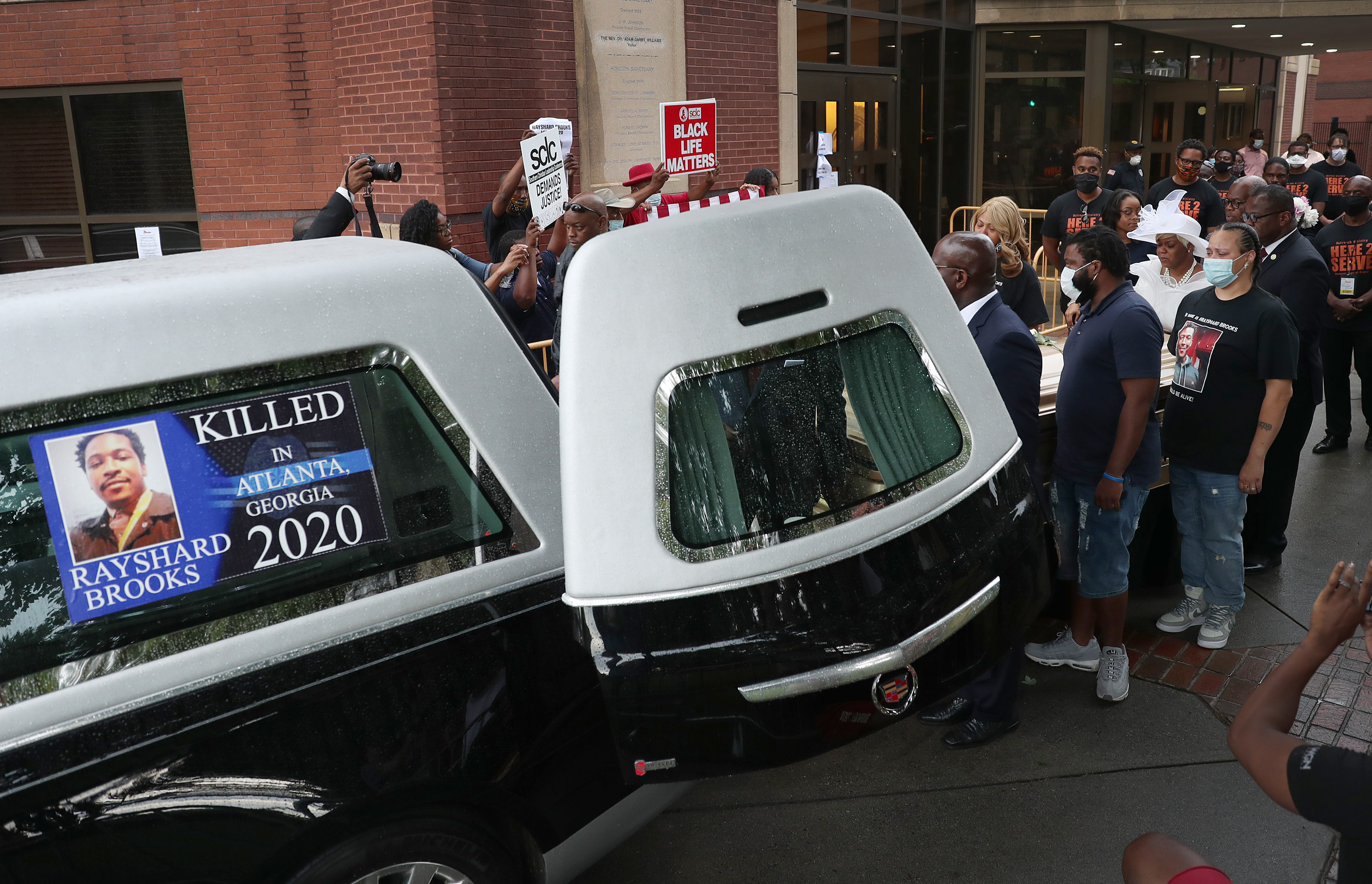 Tomika Miller (in white dress) the widow of Rayshard Brooks follows behind as pallbearers bring the remains of her husband to the hearse after a viewing at the Ebenezer Baptist Church on June 22, 2020 in Atlanta, Georgia. (Joe Raedle/Getty Images)