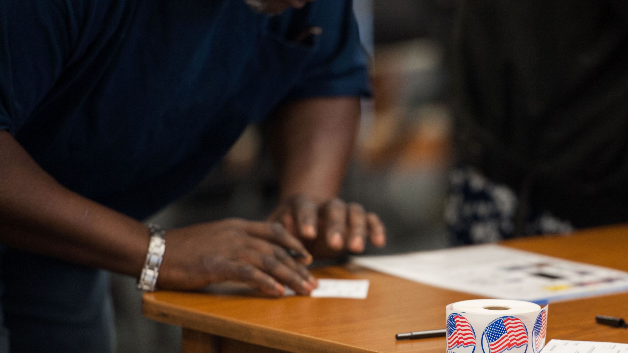 Voting stickers are seen as a man is checked in to receive his ballot during Missouri primary voting on March 15, 2016, in Ferguson, Missouri. (MICHAEL B. THOMAS/AFP via Getty Images)