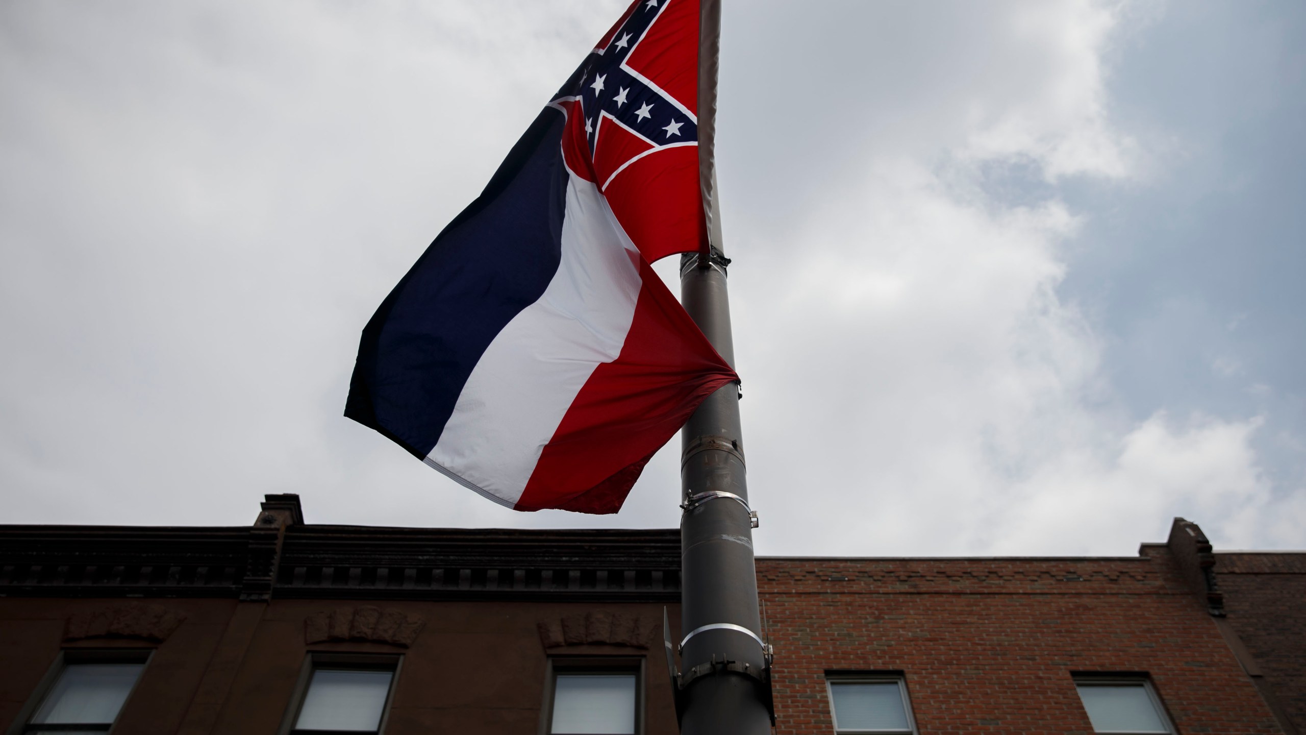 The Mississippi state flag, which features the Confederate emblem, hangs as protestors gathered for a sit-in demanding its removal during a protest at the 2016 Democratic National Convention on July 25, 2016 in Philadelphia. (PATRICK T. FALLON/AFP via Getty Images)