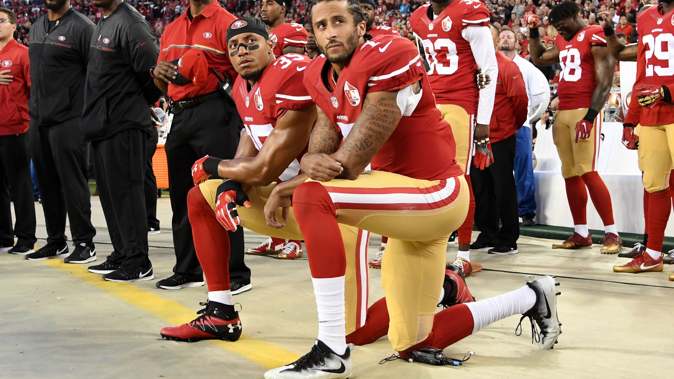 Colin Kaepernick #7 and Eric Reid #35 of the San Francisco 49ers kneel in protest during the national anthem prior to playing the Los Angeles Rams in their NFL game at Levi's Stadium on Sept. 12, 2016, in Santa Clara, Calif. (Thearon W. Henderson/Getty Images)