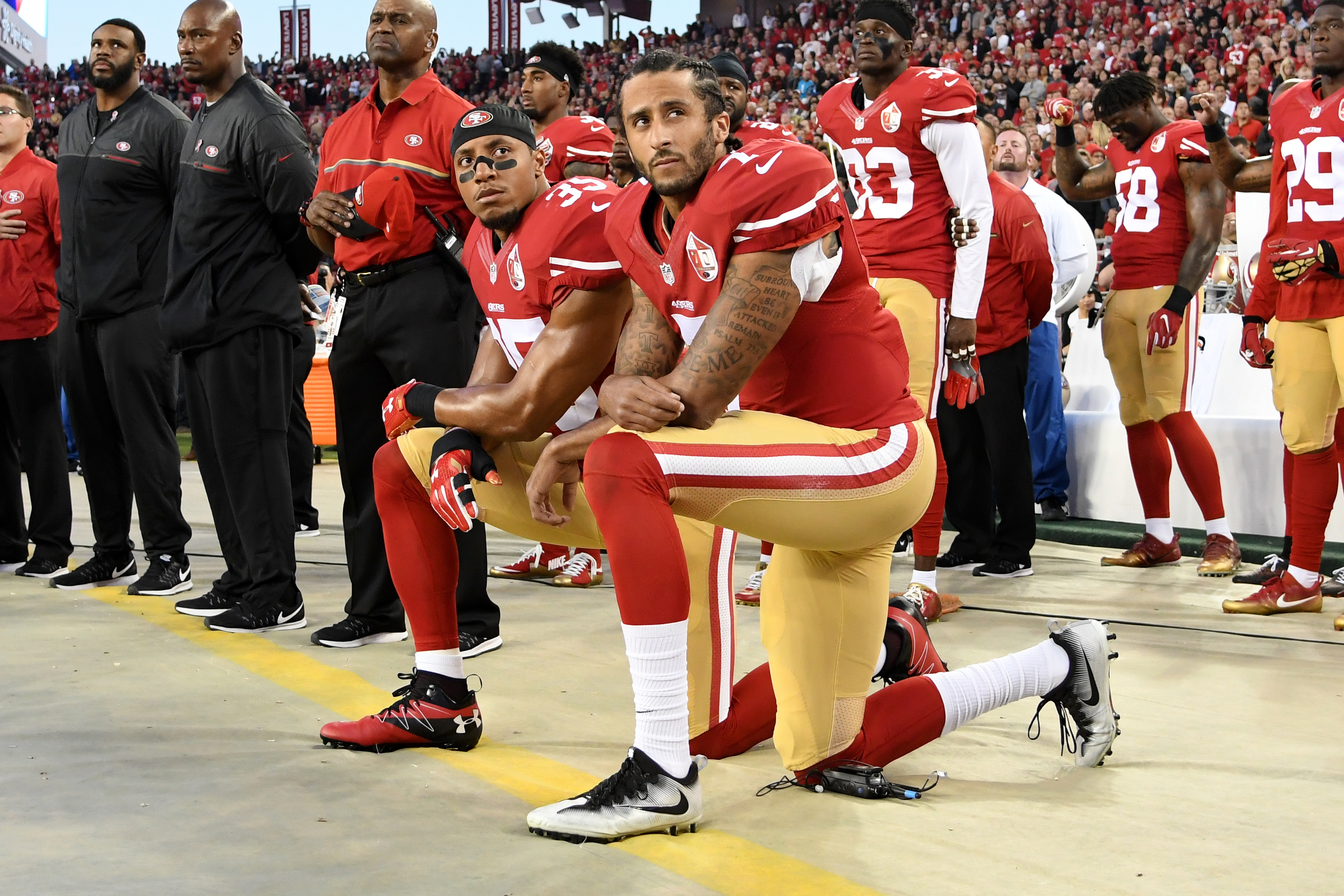 Colin Kaepernick #7 and Eric Reid #35 of the San Francisco 49ers kneel in protest during the national anthem prior to playing the Los Angeles Rams in their NFL game at Levi's Stadium on Sept. 12, 2016, in Santa Clara, Calif. (Thearon W. Henderson/Getty Images)