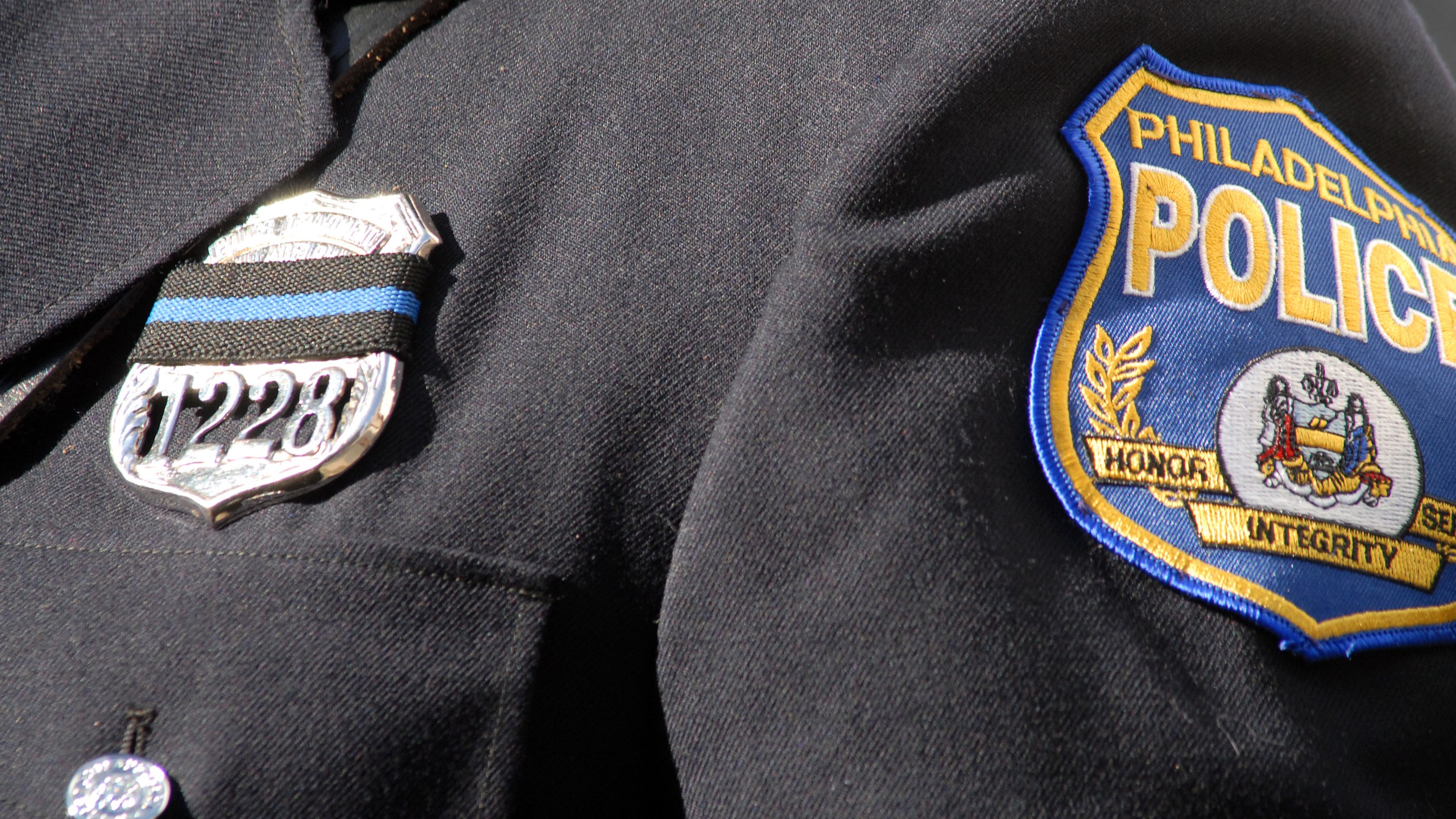 A Philadelphia police officer wears a black ribbon on his badge at the funeral for Philadelphia Police Officer Chuck Cassidy Nov. 7, 2007, at the Cathedral Basilica of Saints Peter and Paul in Philadelphia, Penn. (William Thomas Cain/Getty Images)