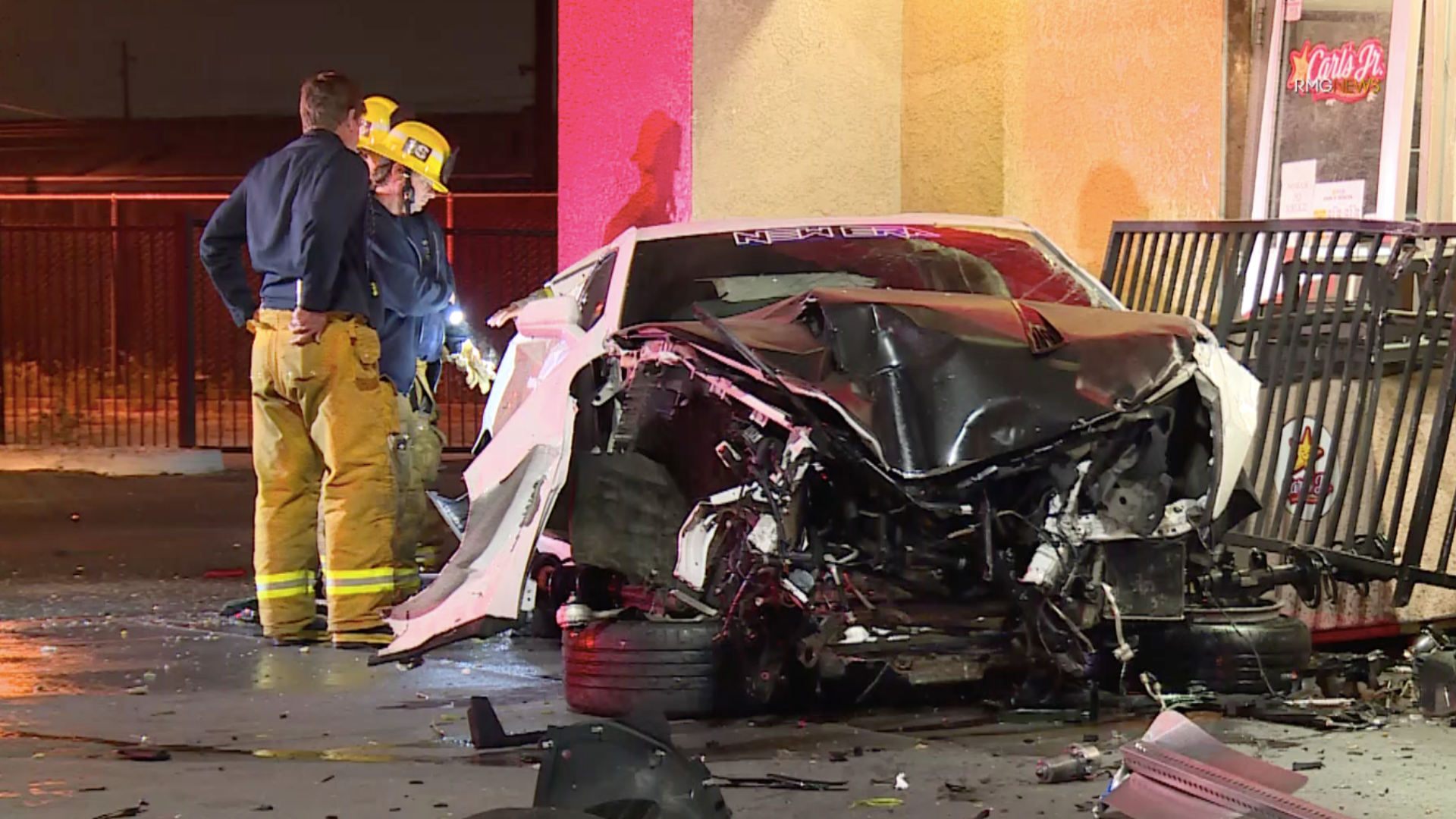 Firefighters assess a vehicle that had crashed into a Carl's Jr. in South Gate on June 26, 2020. (RMG News)