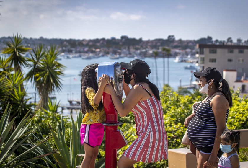 A family takes in the view of Newport Harbor at Lookout Point on Monday.(Allen J. Schaben / Los Angeles Times)