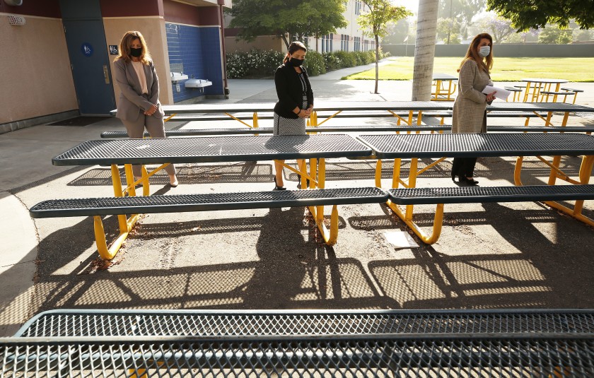 Los Angeles County Office of Education Supt. Debra Duardo, left, and Glendale Unified Supt. Vivian Ekchian, right, are given a tour of Cerritos Elementary in Glendale by Principal Perla Chavez-Fritz on May 26.(Al Seib / Los Angeles Times)